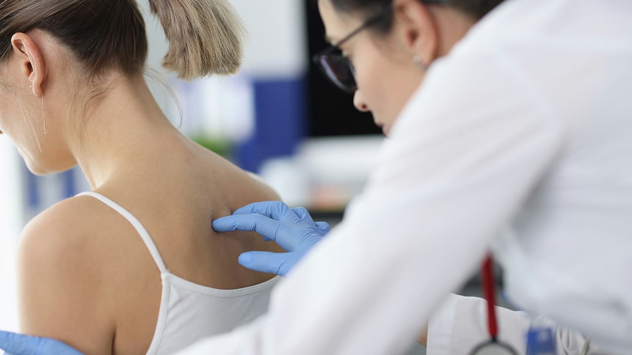 Dermatologist consulting with a patient in a clinical setting