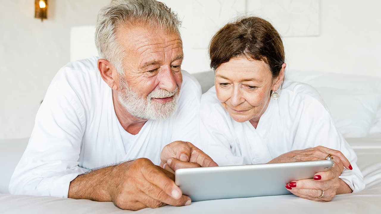 Mature couple browsing wellness products together on a tablet