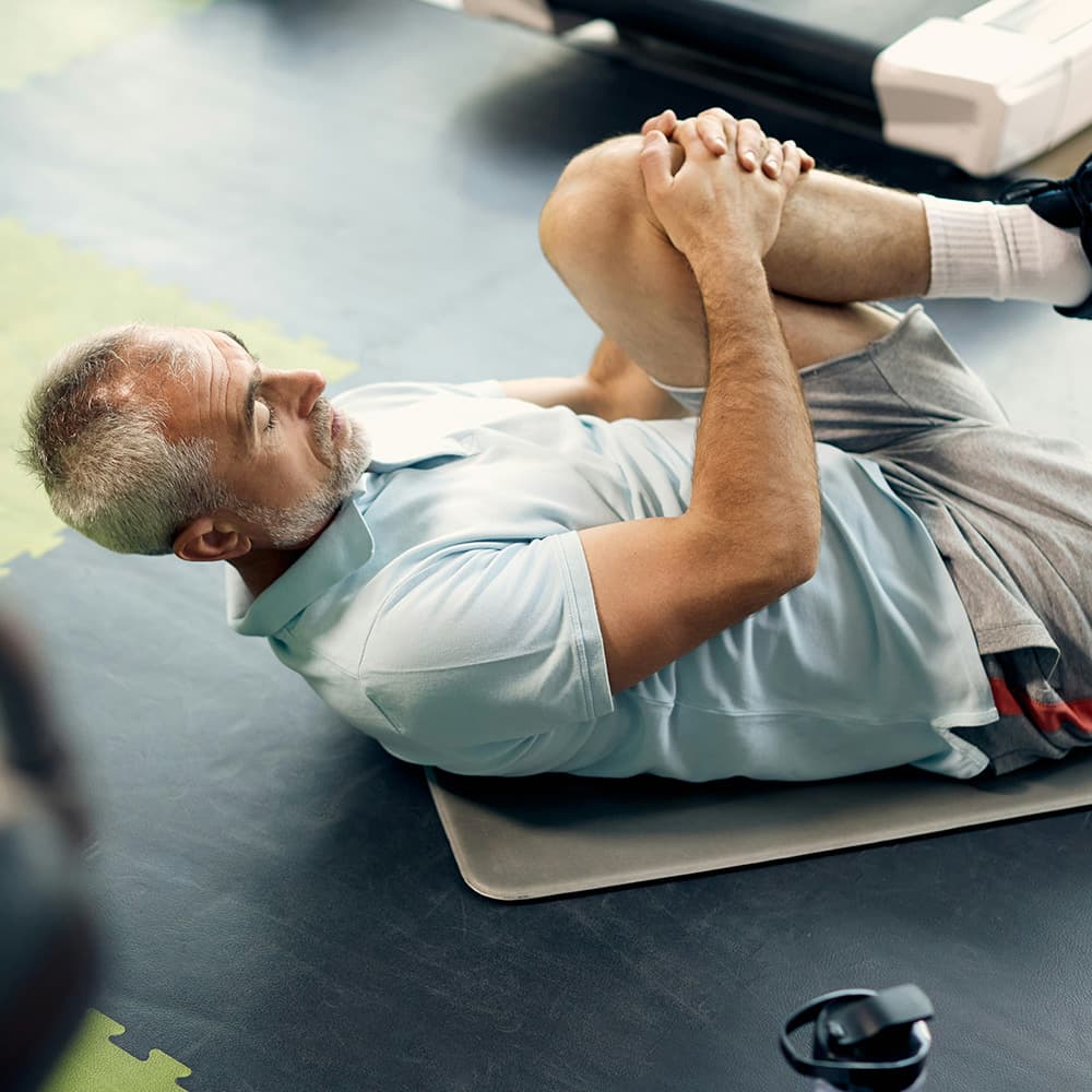 Active older man working out in a gym