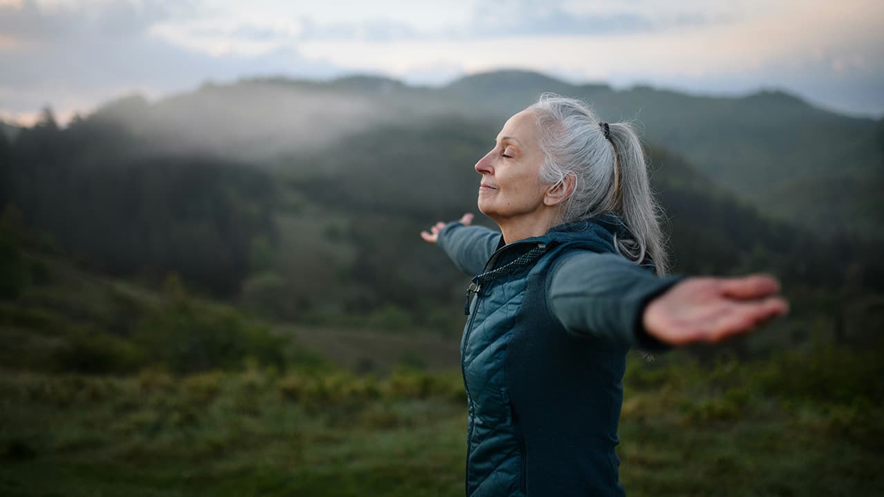 Active older woman enjoying a hike in nature