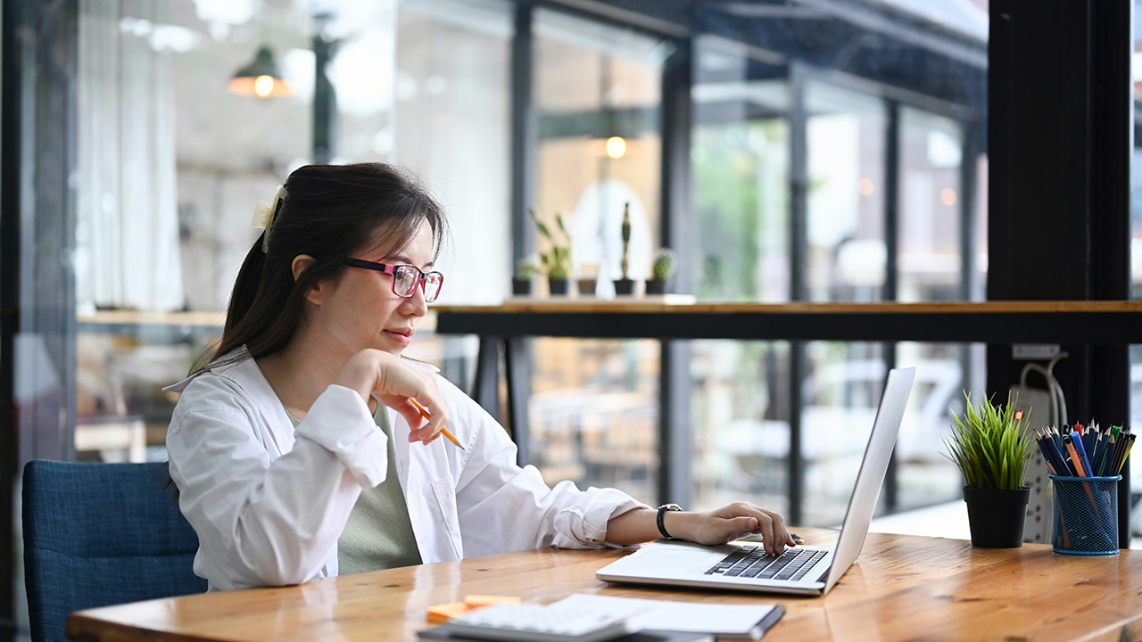 Clinician reviewing medical intake questionnaire on laptop