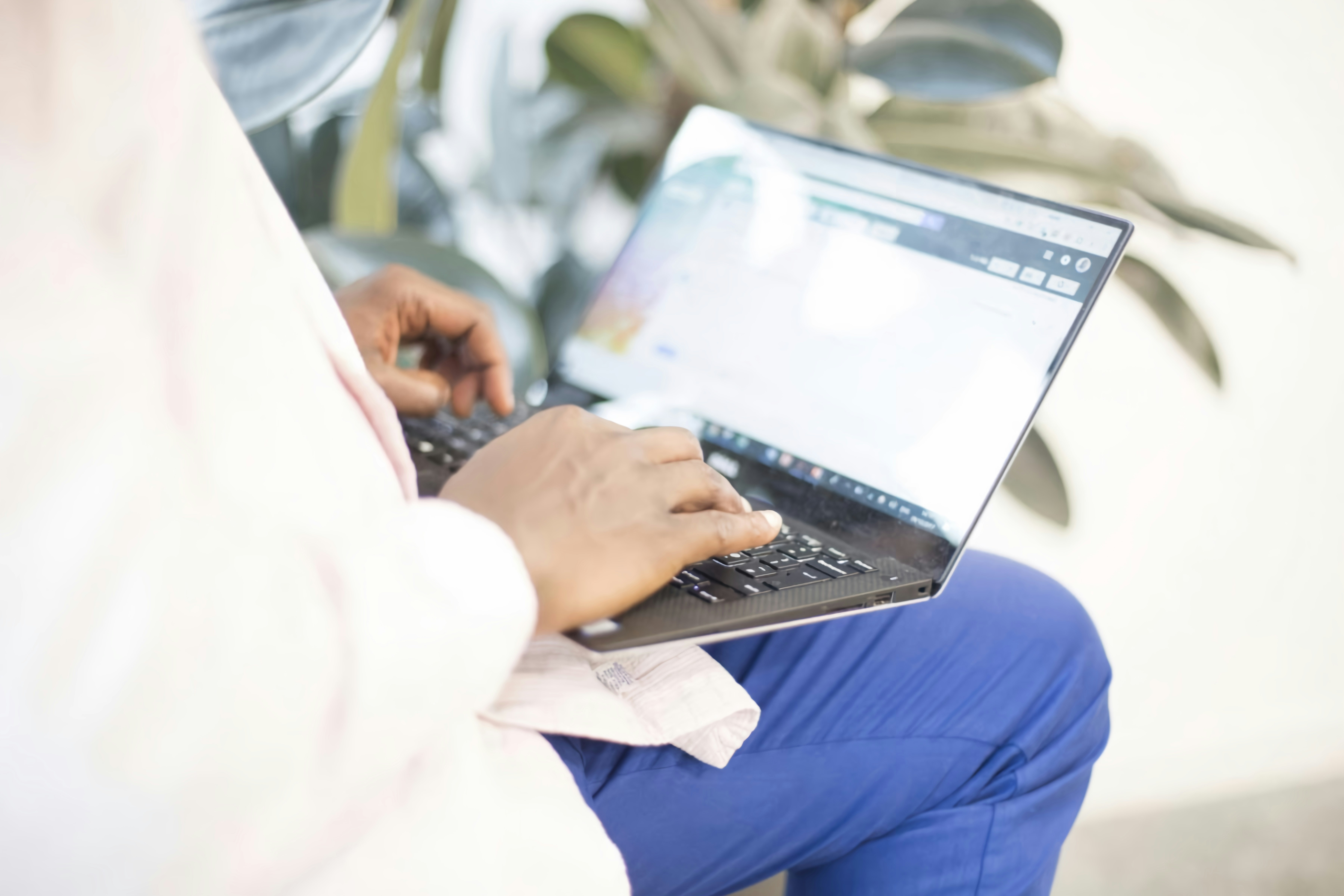 Healthcare professional reviewing compliance data on laptop