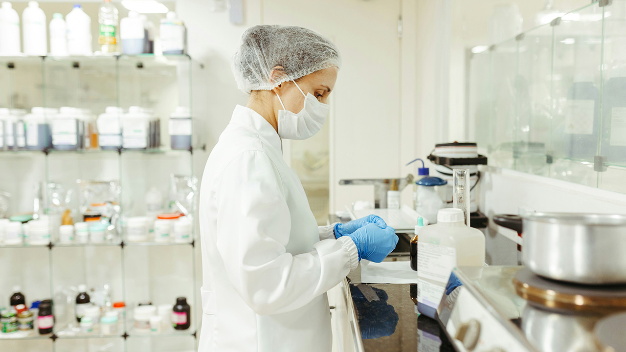 Pharmacy lab worker preparing prescription products